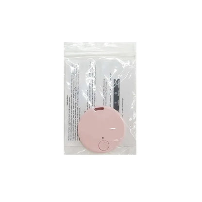 A small, round pink device with a button sits on a clear plastic pouch holding an instruction sheet—your Seamopar Mini GPS Tracker, the compact anti-lost Bluetooth key finder for efficient alerts.