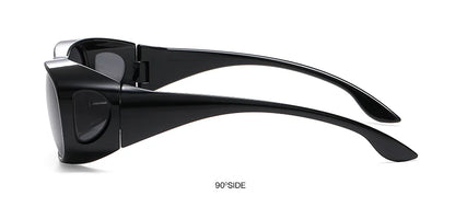 Side view of MOKDUFF Polarized Sunglasses, black wraparound design with wide arms featuring UV400 protection. Shown at a 90-degree angle, these sunglasses combine style and safety for any sunny adventure. Fit over glasses comfortably.