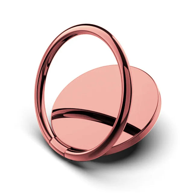 The Luxury Metal 360° Rotation Mobile Phone Ring Holder is a sleek, rose gold accessory with a circular base and swiveling ring. It attaches to the back of a smartphone, offering secure grip or stand functionality with 360° rotation.