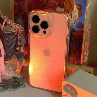Luxury Bling Glitter Clear Phone Case for iPhone Pro Max with sparkling design displayed in warm lighting.