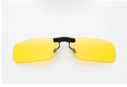 The Honey Joe Polarized Clip-On Sunglasses feature yellow-tinted lenses with UV400 protection, rectangular with rounded edges, and dark metal clasps for easy attachment to regular eyeglasses, set against a plain white background for effortless style and protection.