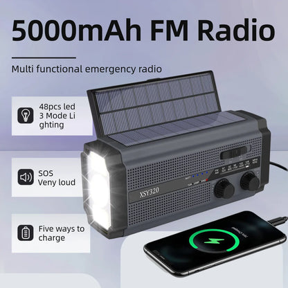 The image showcases the Woopker 5000mAh Emergency Radio, featuring solar and hand crank power. It includes a 48 LED flashlight with 3 modes, a loud SOS alarm, USB phone charging capability, and displays a smartphone being charged next to it.