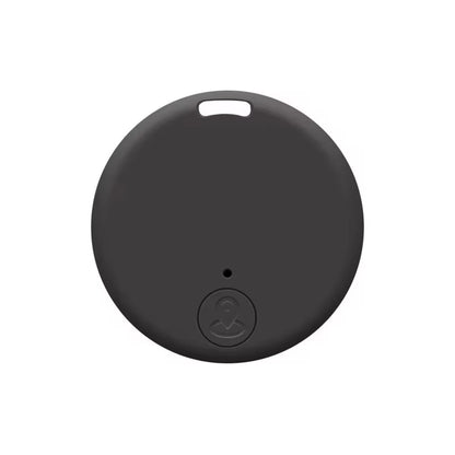 The Mini Bluetooth GPS Tracker - Smart Locator for Pets & Kids is a small, round black device with a matte finish and a small hole near the top. Below it, theres an embossed antenna-like icon. It provides real-time location tracking with its smooth, minimalist surface.