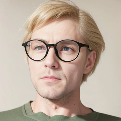 A person with short blonde hair and black-rimmed glasses, featuring OUTMIX Pure Titanium Anti Blue Light Reading Glasses, looks slightly to the side. Wearing a green shirt against a neutral background, they enjoy stylish frames with free shipping—comfort and convenience combined.