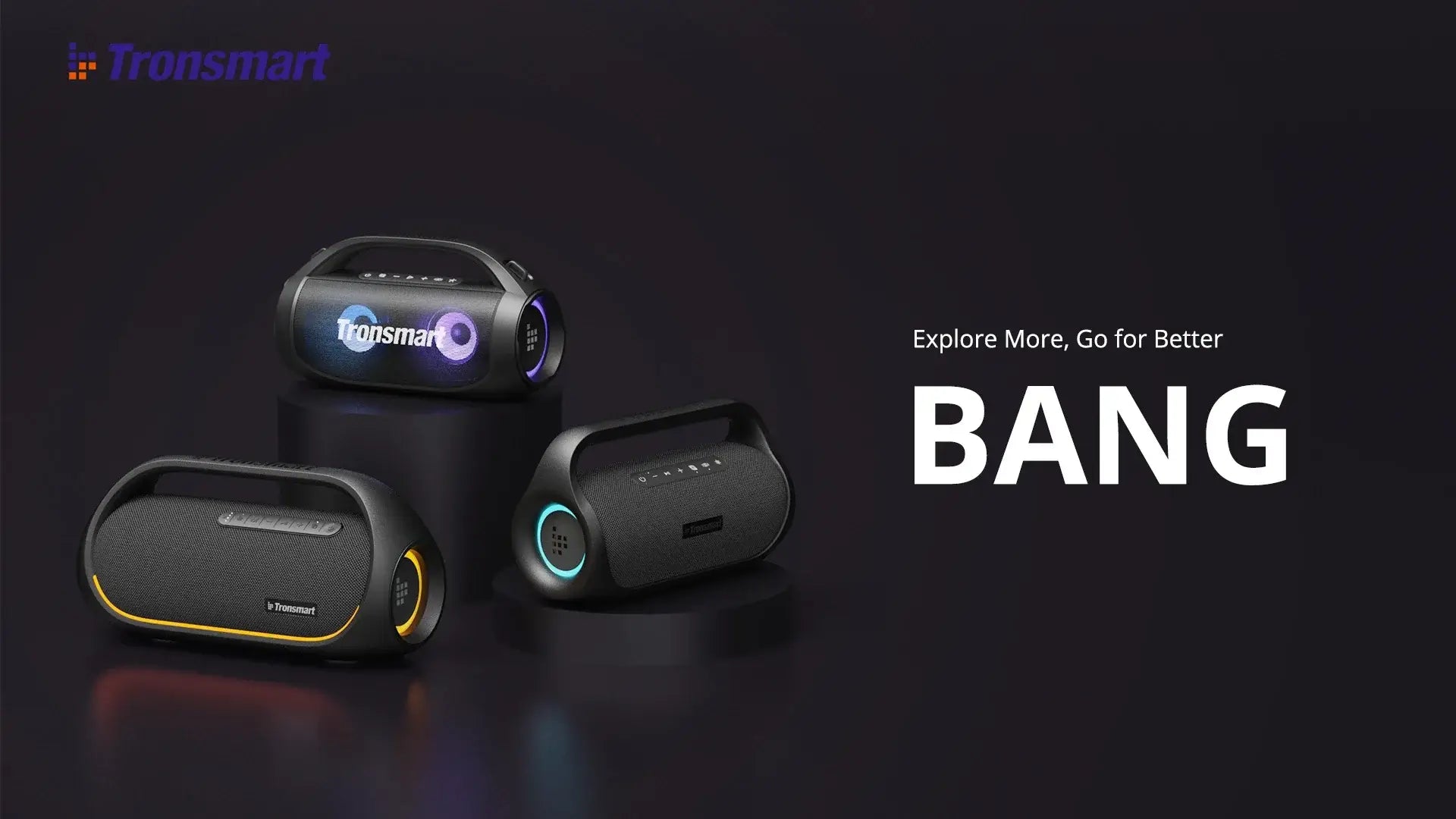 The promotional image displays three Tronsmart Bang 60W Bluetooth Speakers on a dark surface, each featuring colorful LED accents and app control for enhanced heavy bass. The text on the right says, Explore More, Go for Better BANG, with the Tronsmart logo in the top left.