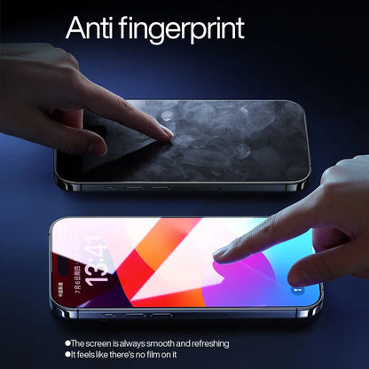 Two smartphones lie on a dark surface. The top one has a smudged display, while the vibrant screen below is shielded by the SmartDevil Tempered Glass Screen Protector for iPhone 16 Pro Max, labeled Anti fingerprint, which hints at advanced anti-blue light features.