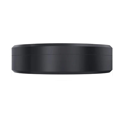 Viewed from the side, the sleek, smooth, and minimalist design of a black, round Mini GPS Tracker - Real-Time Magnetic Smart Locator has no visible buttons or features. Its streamlined appearance is highlighted by lighting against a plain white background.