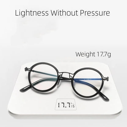 KLASSNUM Mens Round Glasses lie on a digital scale displaying 17.7g. The stylish retro black frames offer Lightness Without Pressure and provide anti-blue light protection without the weight.