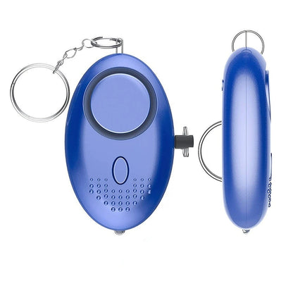 A sleek, blue oval-shaped 130dB Personal Safety Alarm Keychain with a circular front button and small speaker grille offers instant alerts. Featuring a slim side profile, its perfect for personal safety.