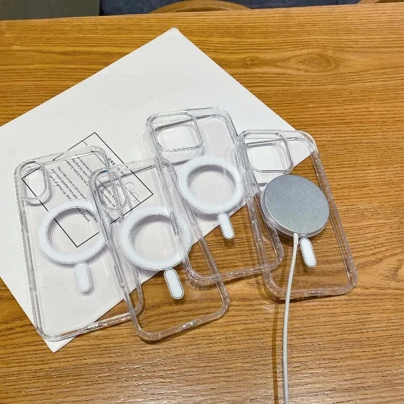 Transparent PC phone cases with MagSafe wireless charging, showcasing design and functionality on a wooden table.